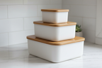 White storage boxes with rounded bottoms on counter